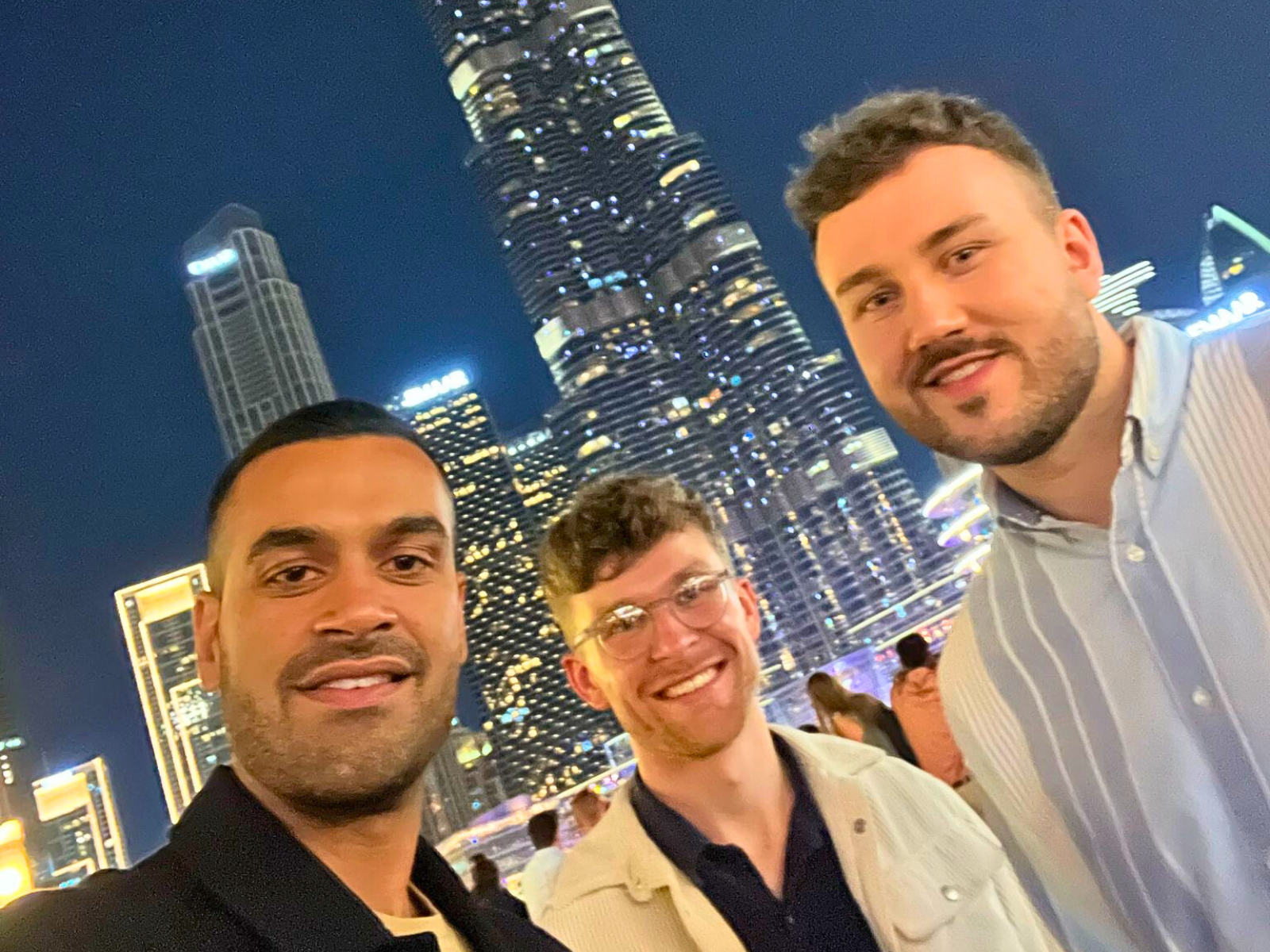 Siren team with Dubai skyline at night